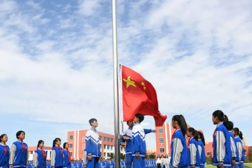 Students attending a formal flag-raising ceremony at Mingde School